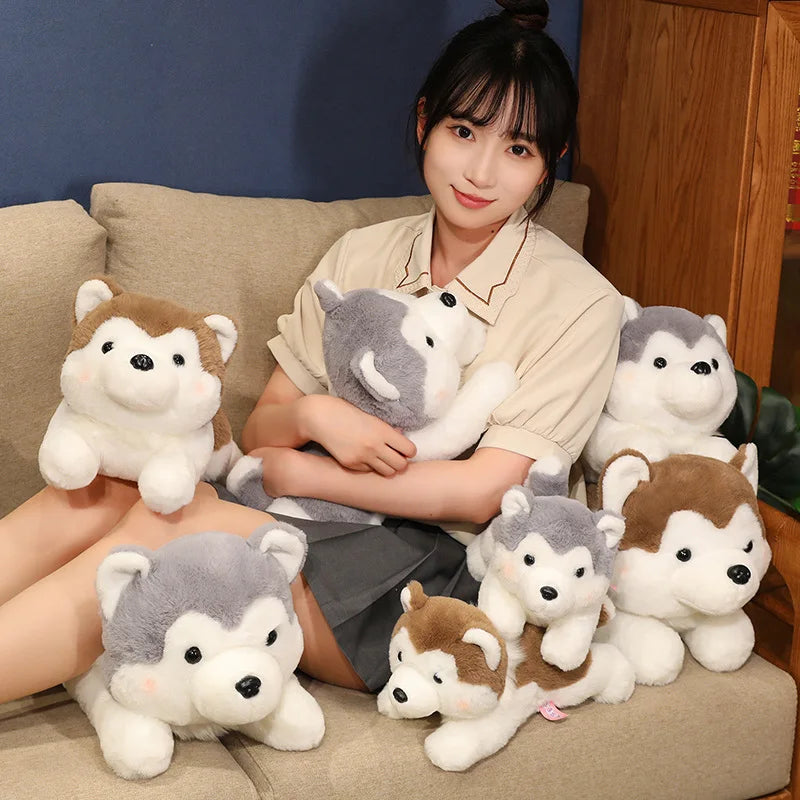 Woman sitting on a couch with multiple plush husky kawaii toys around her