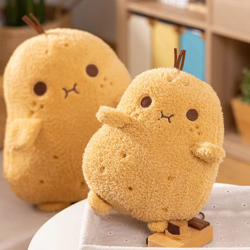 Two plush kawaii toys resembling yellow birds on a white surface with a blurred background