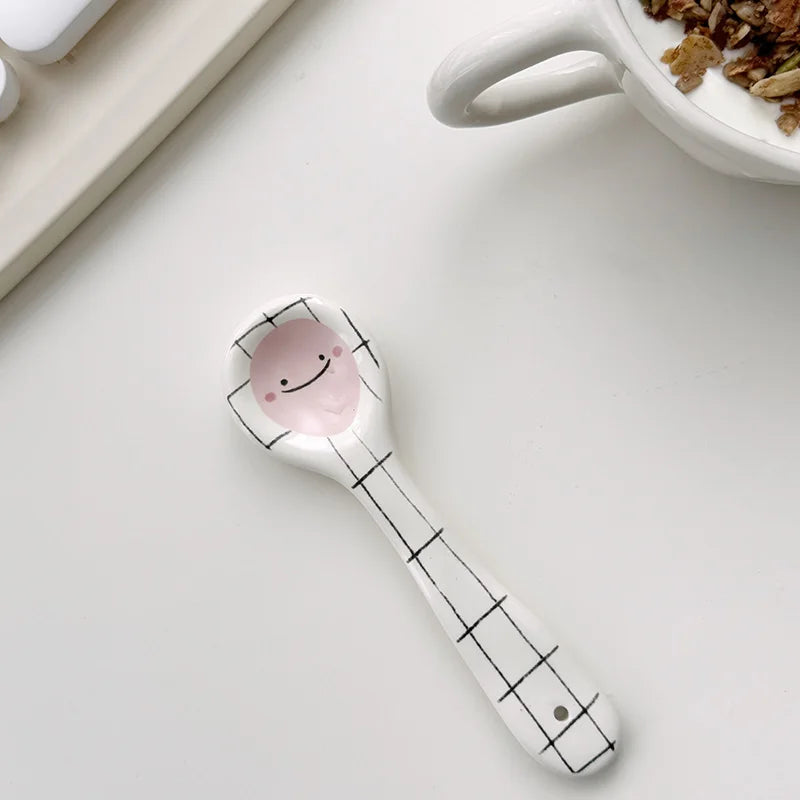 Kawaii spoon with a smiley face design on a white surface