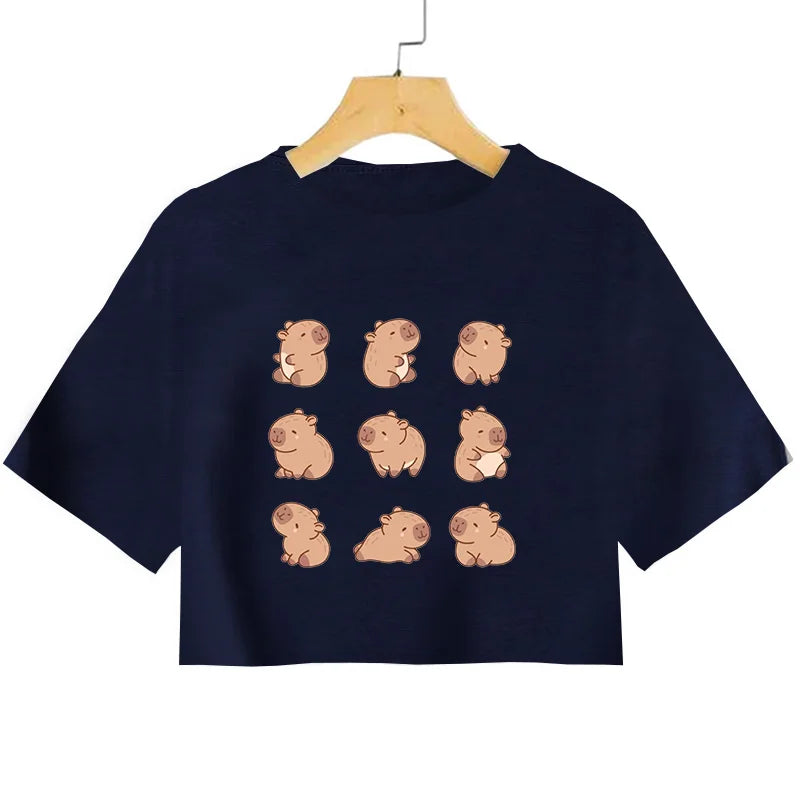 Navy blue crop top with kawaii cartoon pig designs on a hanger against a white background