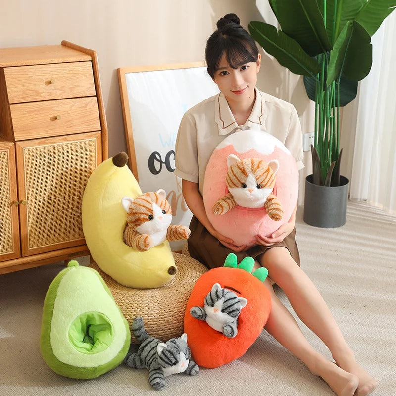 Woman holding a cat-shaped kawaii pillow surrounded by avocado, banana, and carrot-shaped cushions in a room.