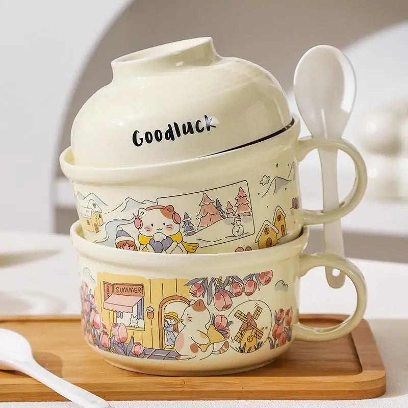 Two ceramic kawaii ramen bowls with cartoon designs and a lid labeled 'Goodluck' on a wooden surface.