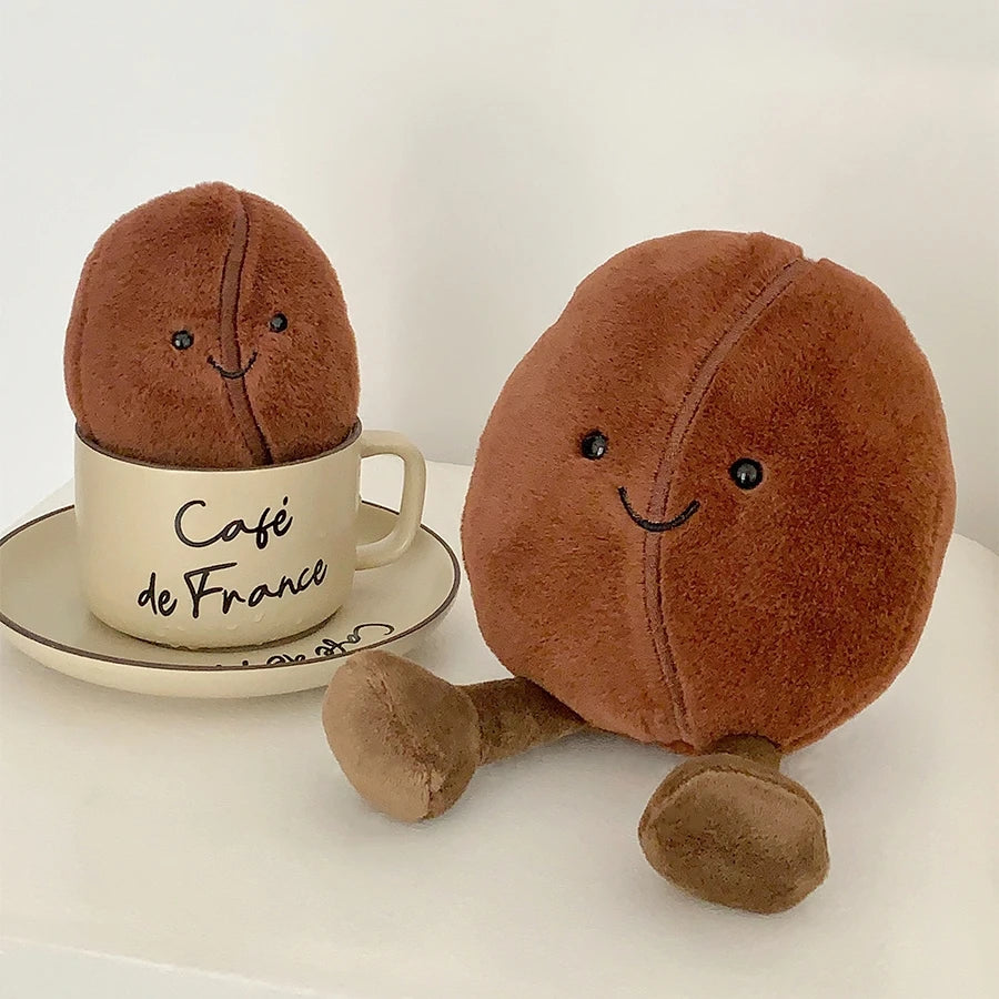 Two kawaii plush coffee beans with a 'Café de France' cup on a white background