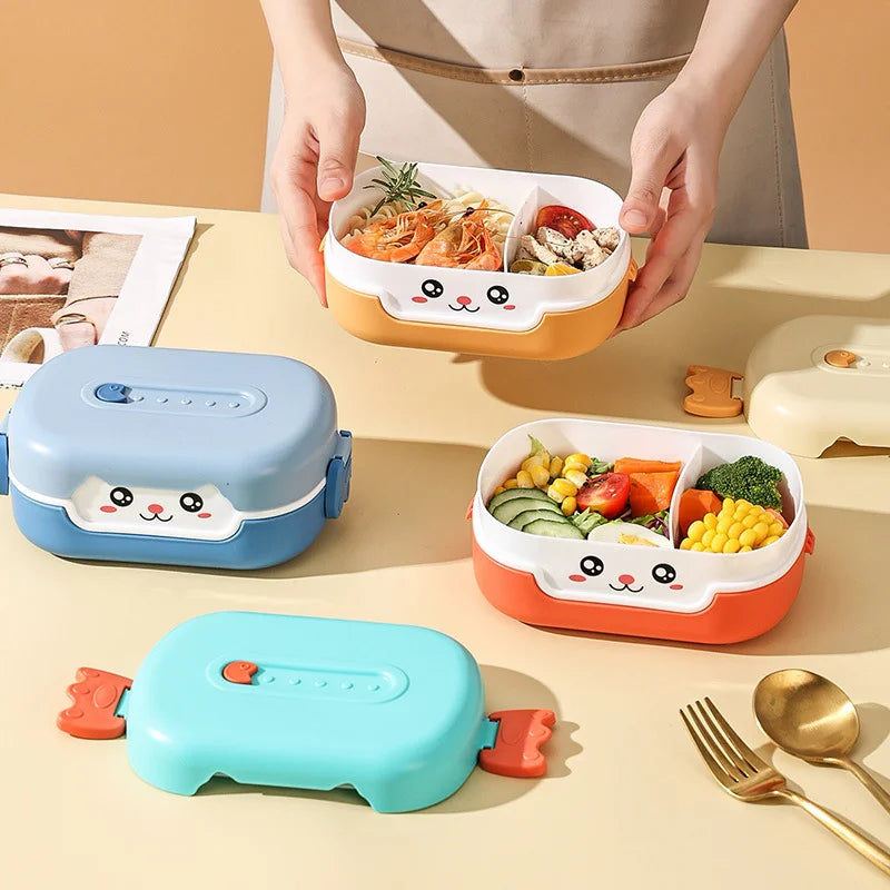 Three colorful kawaii bento boxes with cartoon faces on a table with food and utensils.