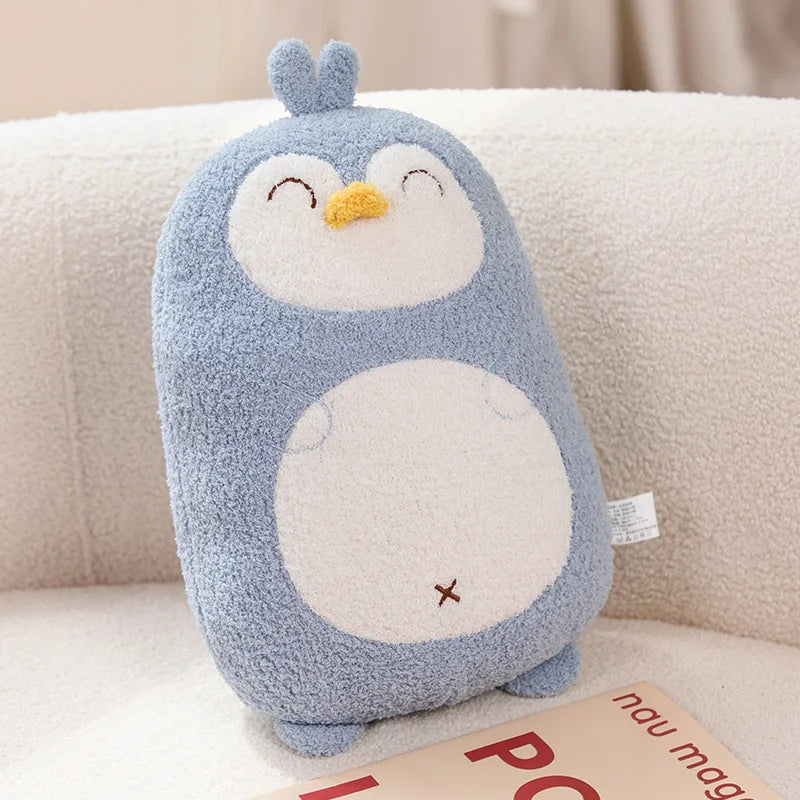 Kawaii plush penguin toy on a beige surface