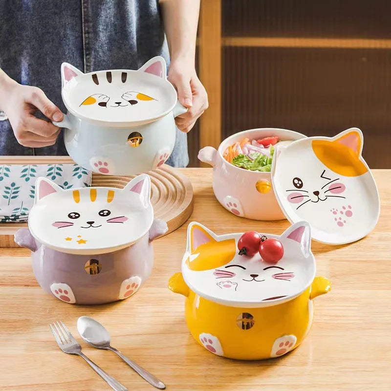 Set of cat-shaped ceramic kawaii ramen bowls with lids on a wooden table.