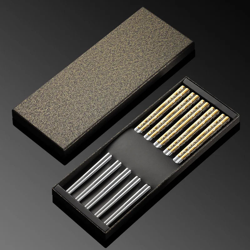Set of metal kawaii chopsticks in a black box on a dark background