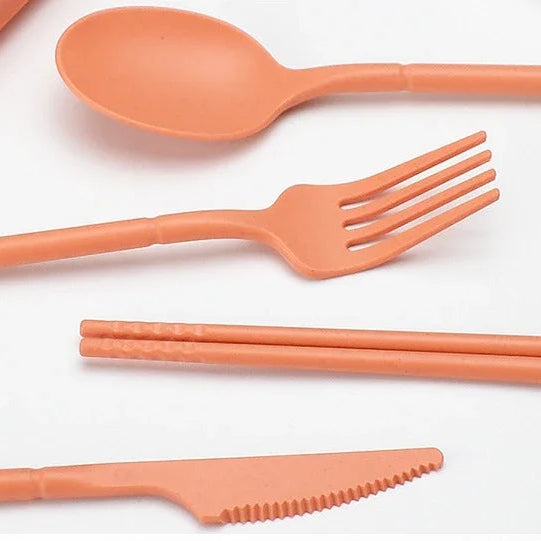 Close up of a set of orange kawaii utensils