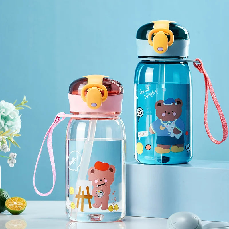 Two children's kawaii water bottles with cartoon designs on a light blue background