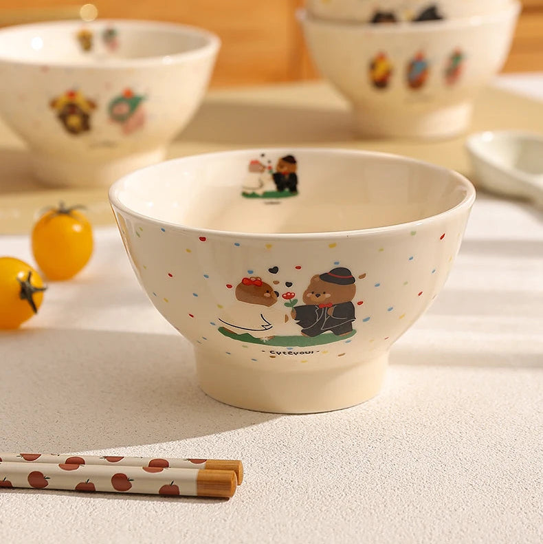 Ceramic kawaii ramen bowls with cartoon designs on a table