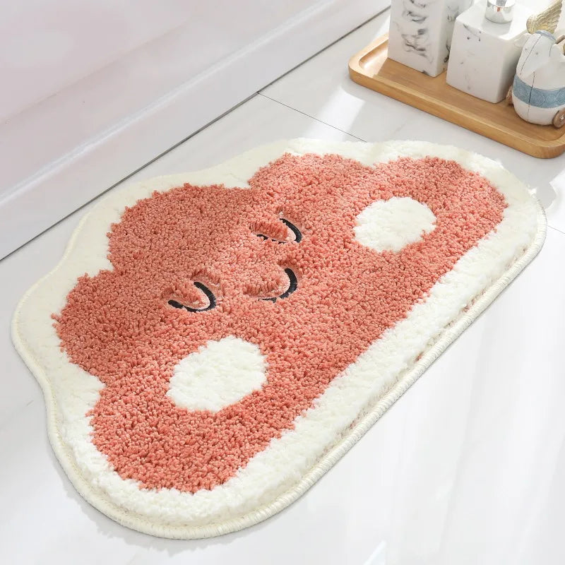 Pink kawaii bath mat on a bathroom floor
