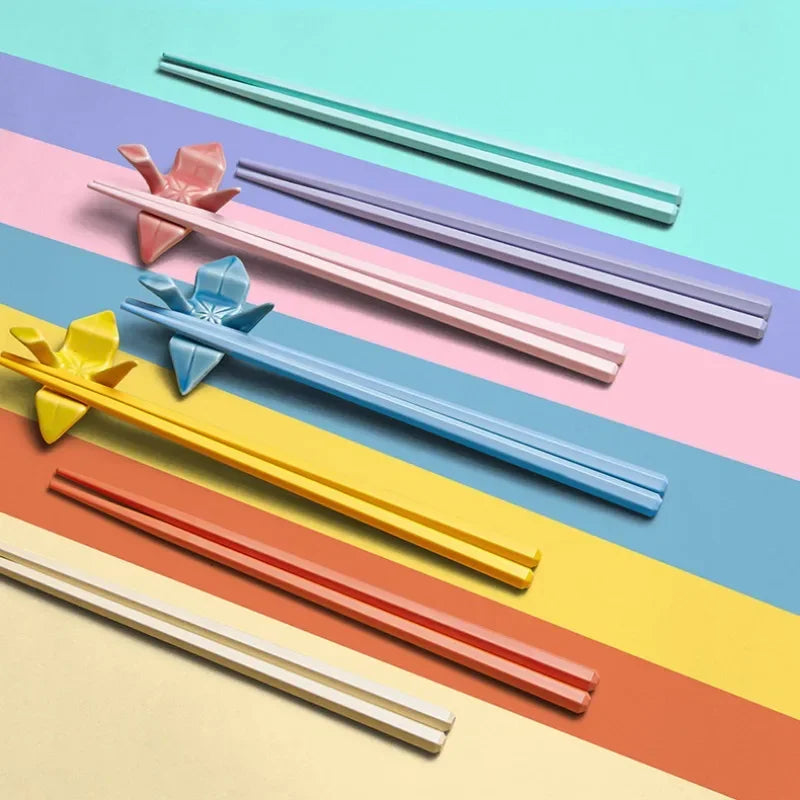 Colorful kawaii chopsticks on a multicolored striped background