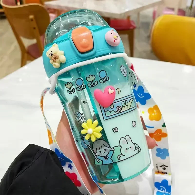 Children's kawaii water bottle with cartoon designs held by a person in a casual setting.