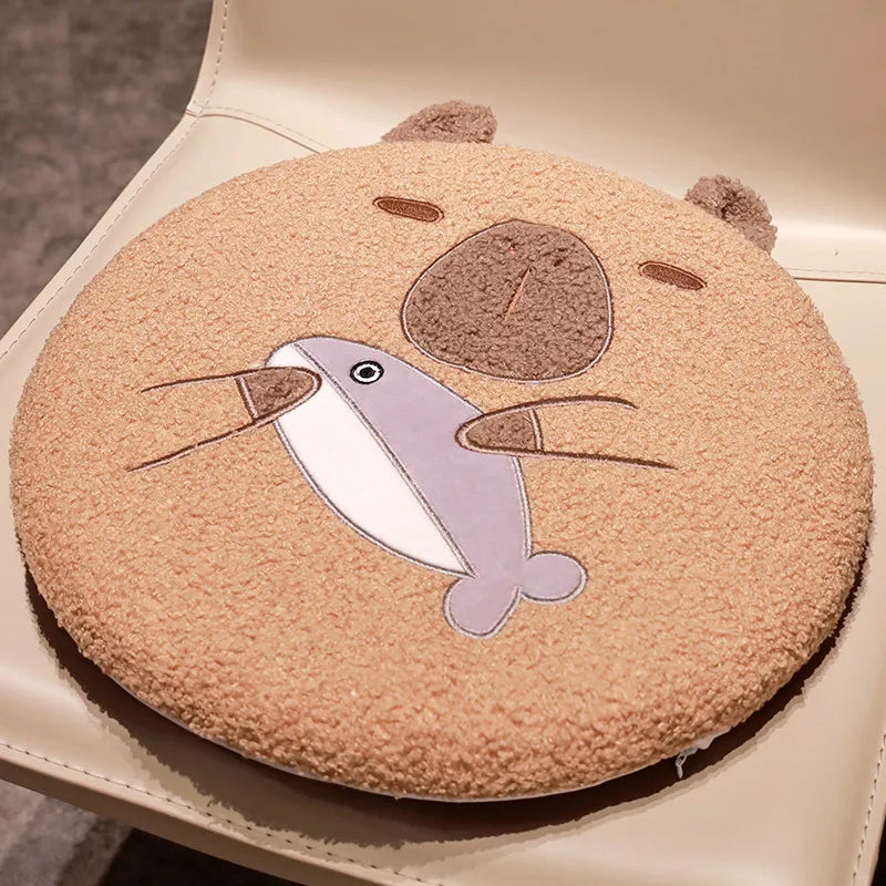 Round kawaii cushion with a cartoon narwhal design on a beige background