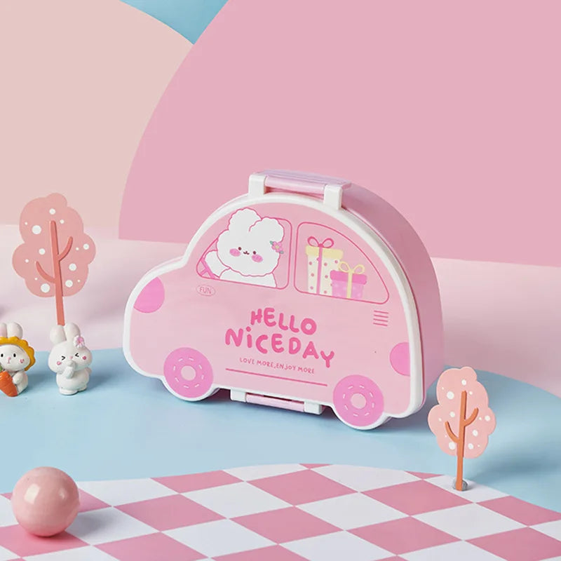 Pink car-shaped kawaii box with cartoon design on a checkered floor with decorative trees and animals.