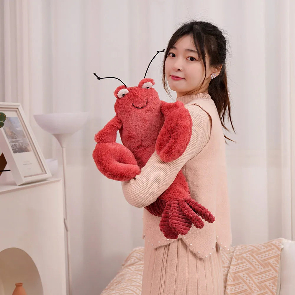 Woman holding a large red kawaii plush lobster toy indoors.
