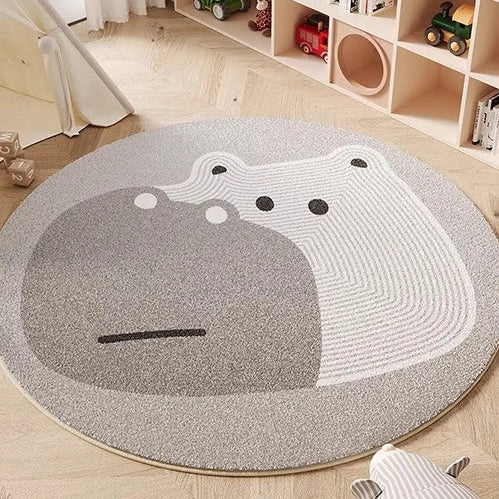 Round gray kawaii rug with a cartoonish design of a face on a wooden floor.