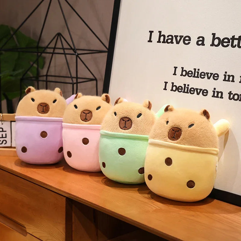 Four cute kawaii animal-shaped plushies on a wooden surface with a motivational quote in the background.