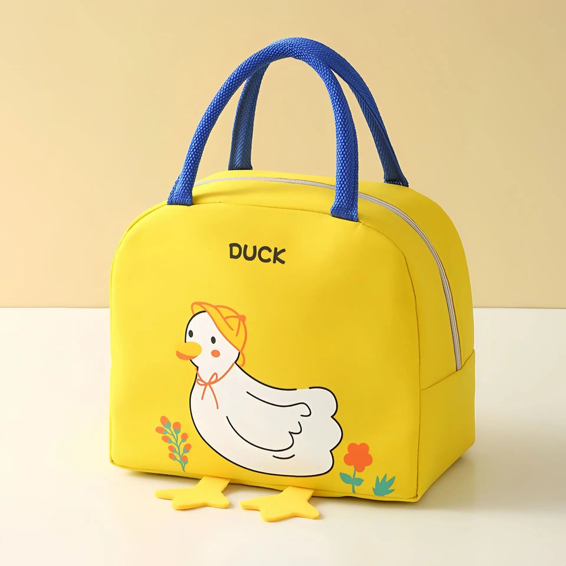 Yellow kawaii bag with a duck design and blue handles on a beige background