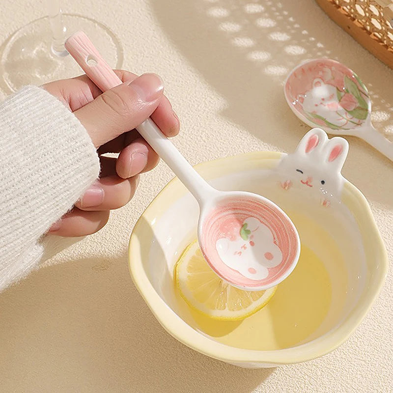 A person holding a white and pink kawaii spoon