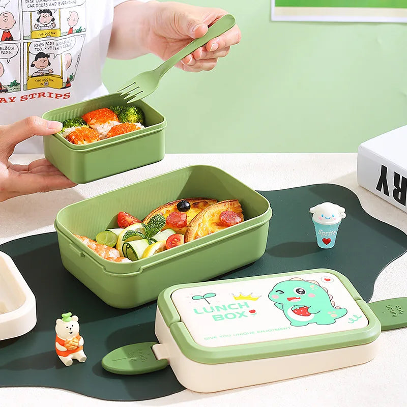 Green kawaii lunch box with food and a fork, placed on a tray with a cartoon character design.