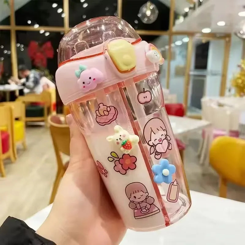 Cute cartoon-themed kawaii water bottle held in a hand with a blurred restaurant interior in the background