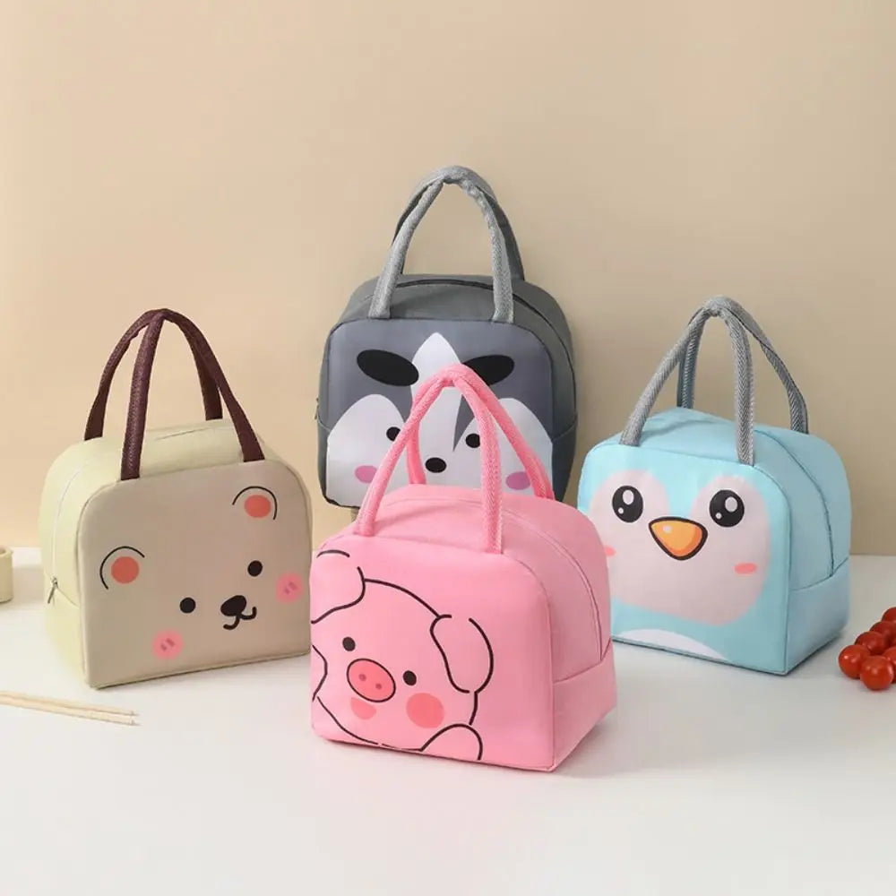 Four cartoon-themed kawaii lunch bags on a light surface with a beige background