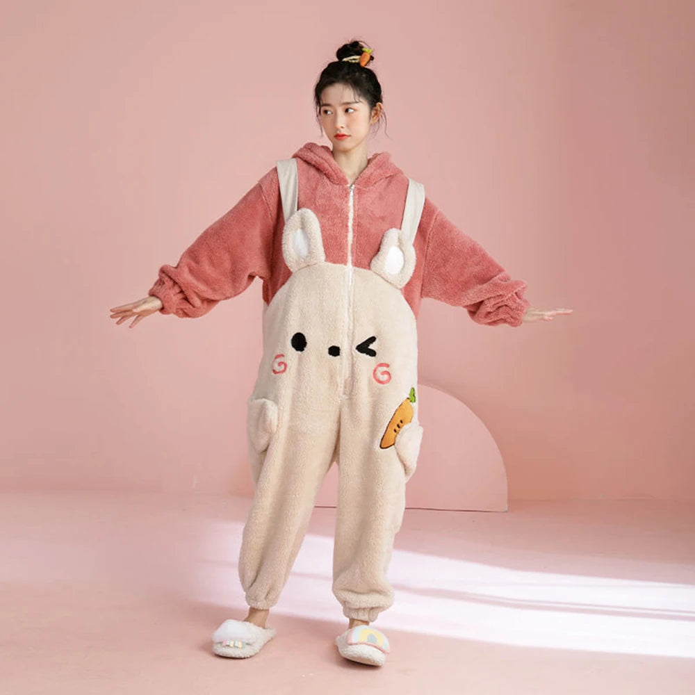Person wearing a pink hoodie and beige onesie with kawaii cartoon design on a pink background