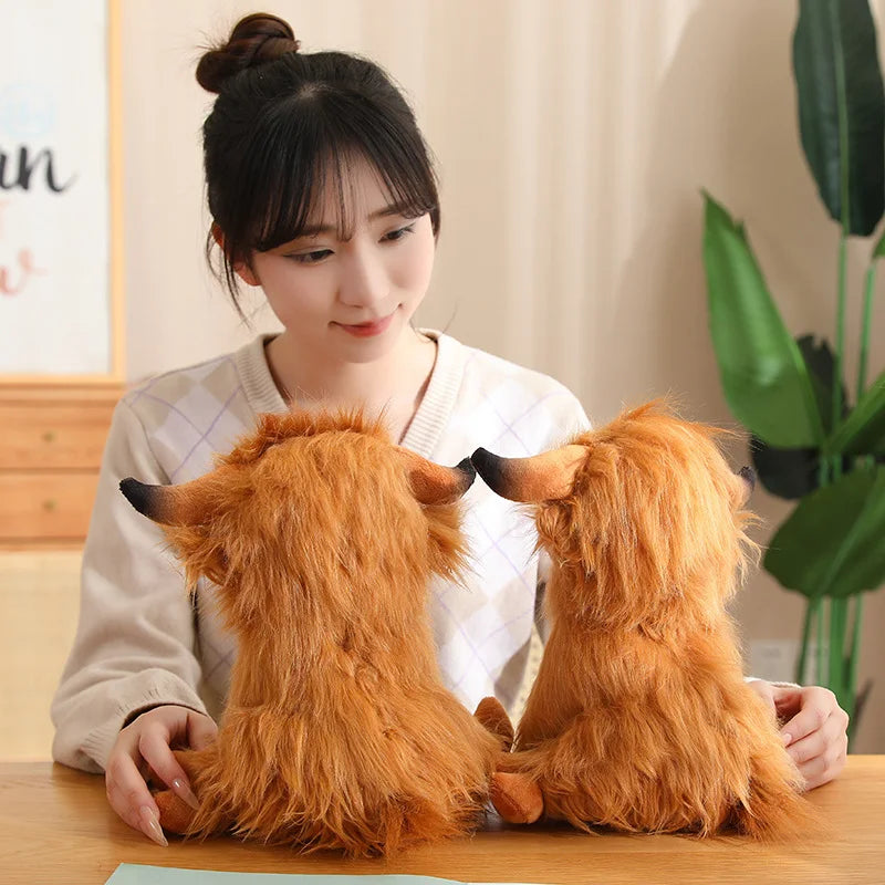 Person holding two fluffy brown dog-shaped kawaii plush toys on a wooden table.