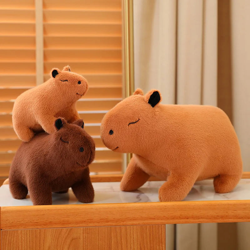 Three kawaii plush bears of different sizes on a wooden surface with a mirror in the background.