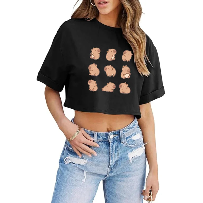 Black crop top with kawaii cartoon bear prints worn by a person, paired with light blue jeans on a white background.