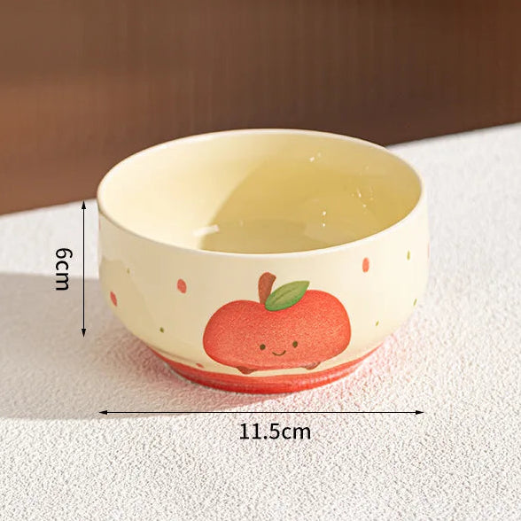 Small ceramic kawaii bowl with apple design on a textured surface, showing dimensions.