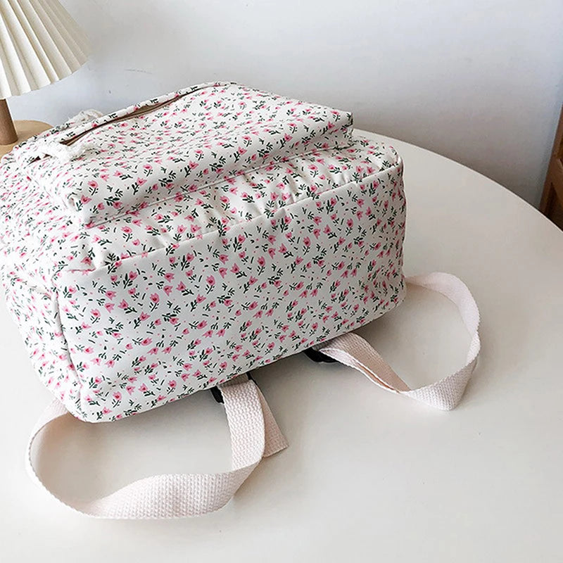 Kawaii floral-patterned backpack on a white surface with a neutral background