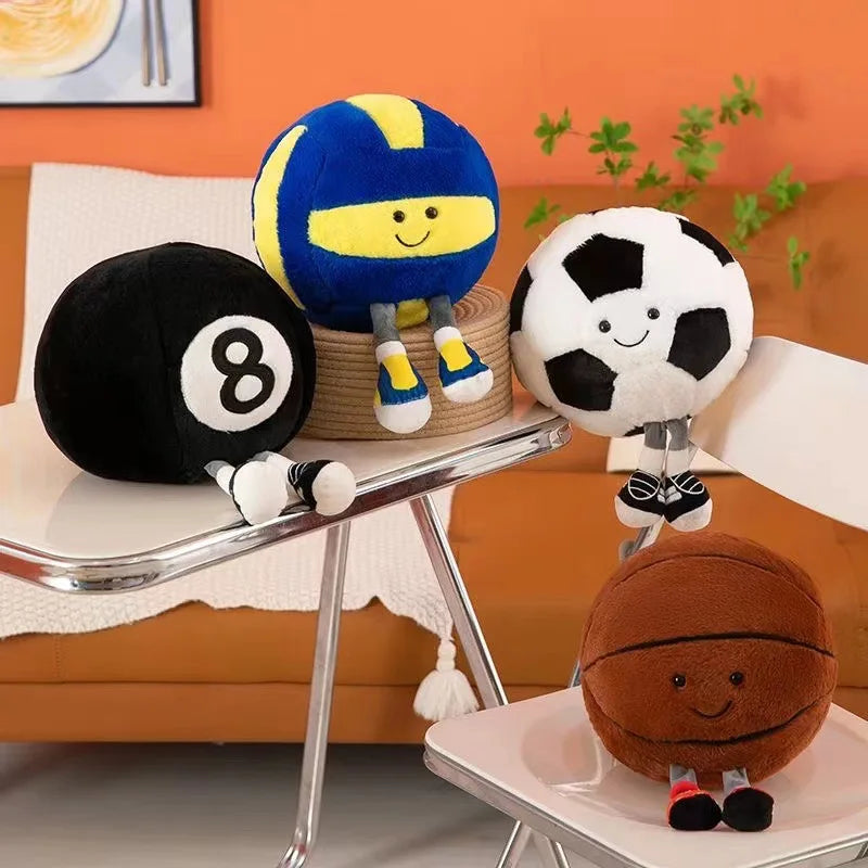 Kawaii plush toys resembling sports balls on a table with an orange wall and plant in the background