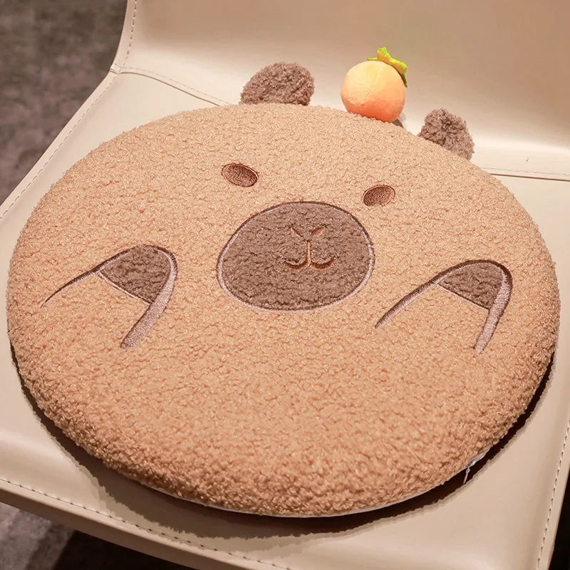 Round kawaii cushion with a bear face design on a beige surface