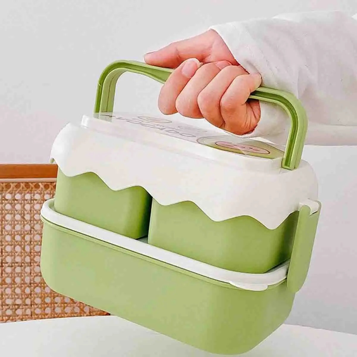Green and white kawaii food container with a handle held by a person