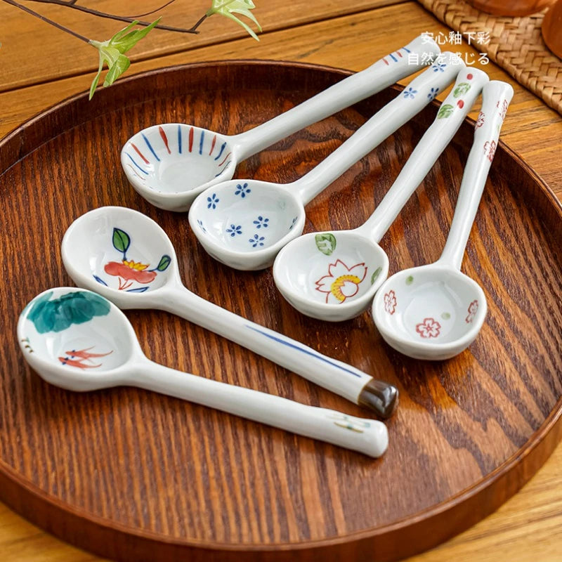 A set of ceramic kawaii spoons sitting on a table