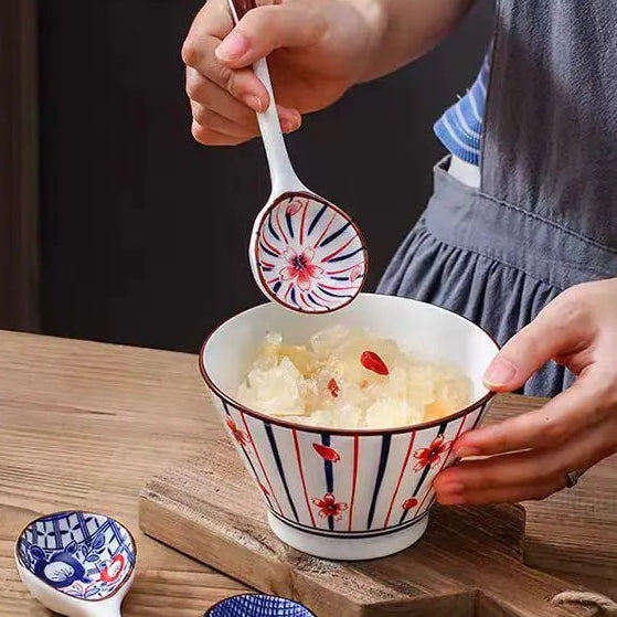 A person holding a white ceramic kawaii spoon