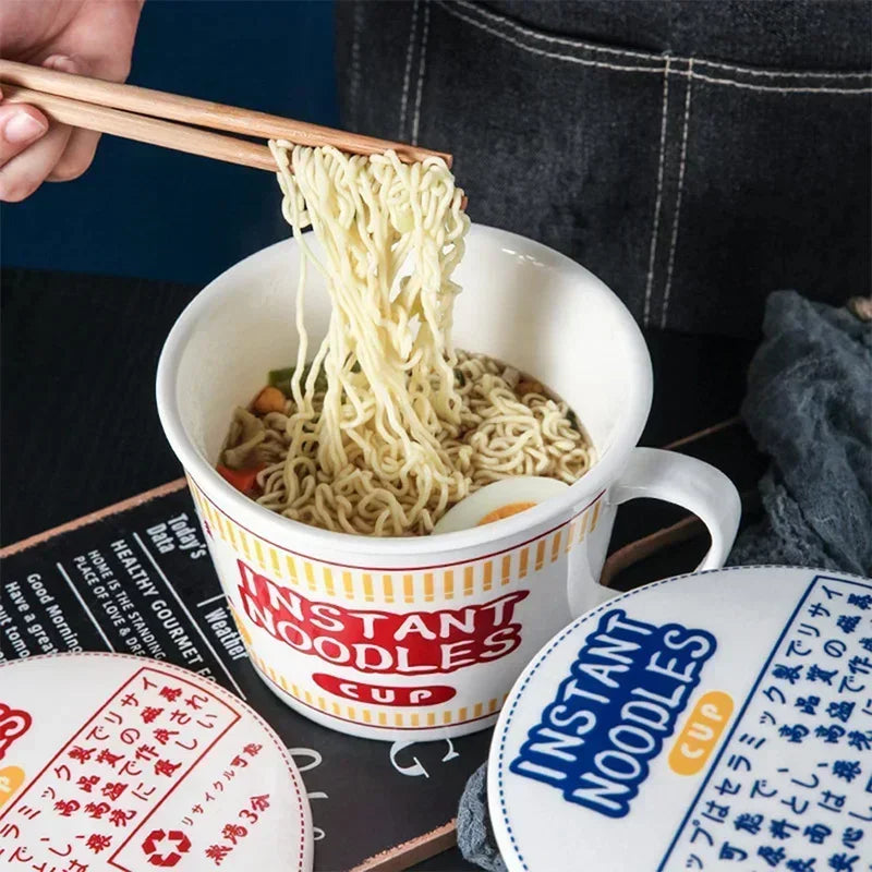Someone eating instant noodles from a kawaii ramen bowl