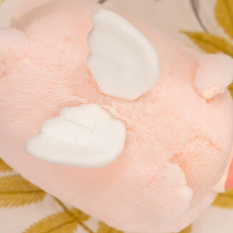 Close-up of a pink kawaii plush toy with white accents on a patterned background