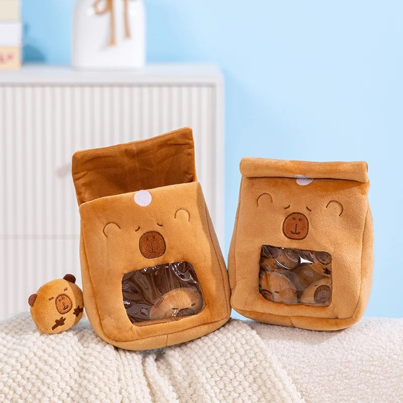 Two brown capybara kawaii-shaped bags with clear windows on a textured surface with a light blue background.