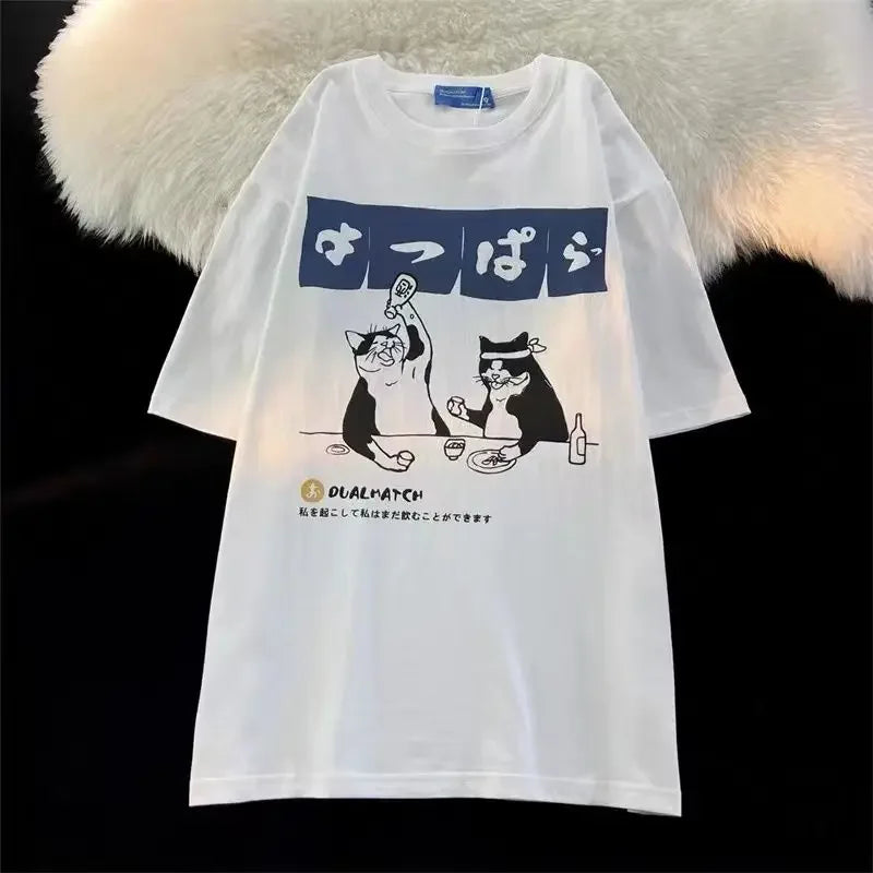 White t-shirt with kawaii cartoon design featuring two cats and Japanese text on a fur background.