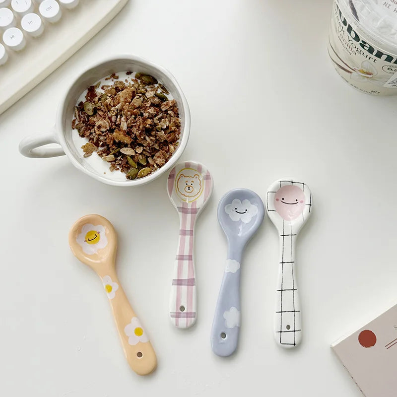 A group of four kawaii spoons on a kitchen table