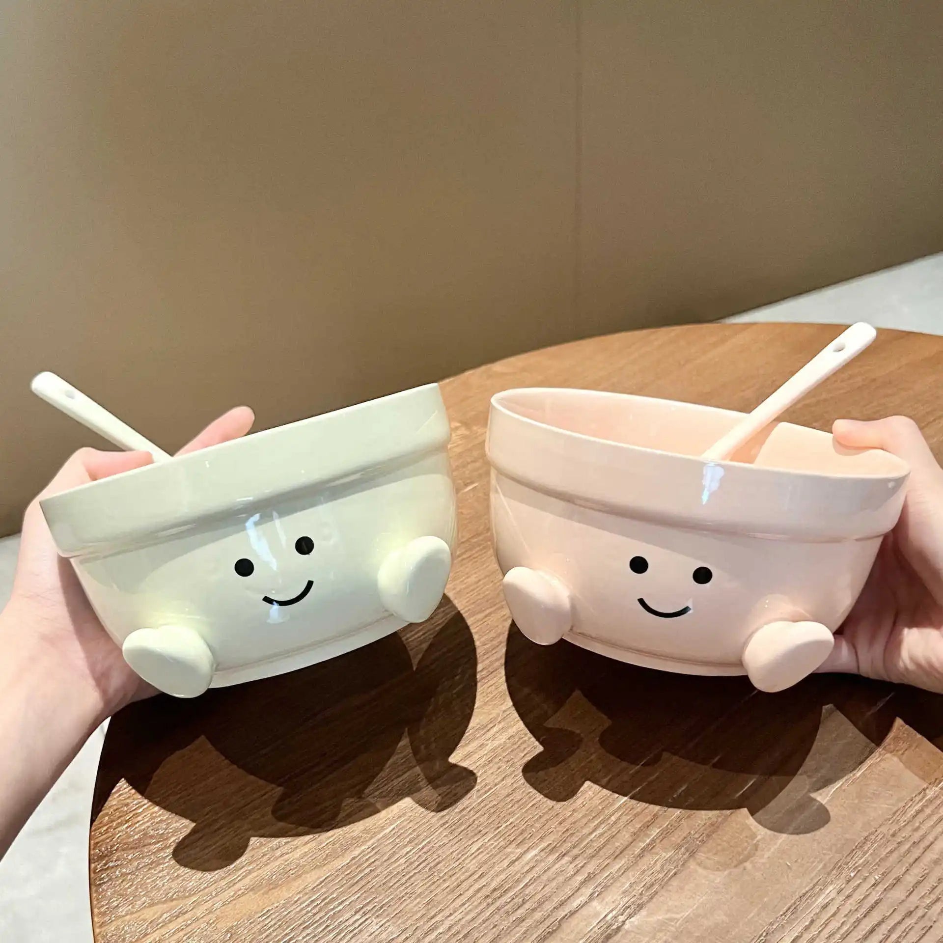 A set of two kawaii bowls, one pink and the other green