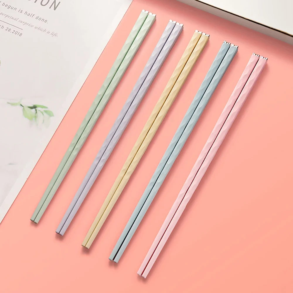Set of colorful kawaii chopsticks on a pink surface