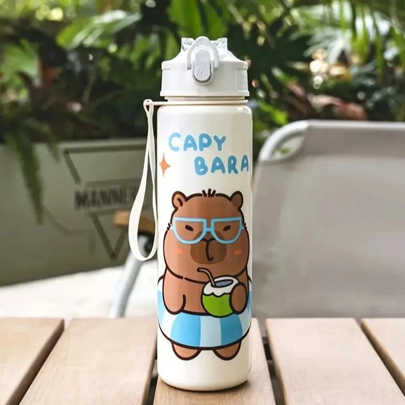 White kawaii water bottle with cartoon bear design and 'Capy Bara' text on a wooden surface.