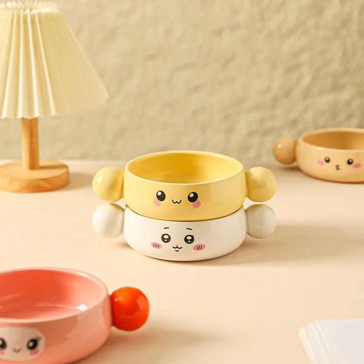 Ceramic kawaii ramen bowls with cute designs on a beige surface