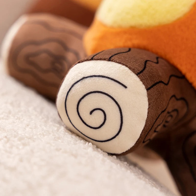 Close-up of a kawaii plush toy with a tree trunk design on a soft surface