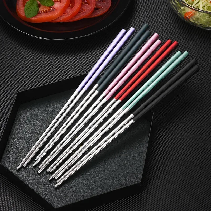 Set of colorful kawaii chopsticks on a black tray with a dark background