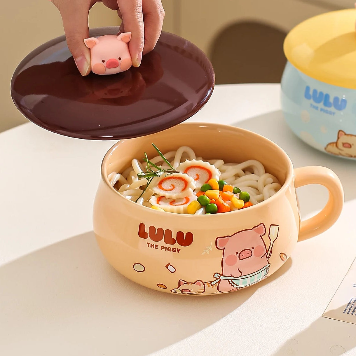 Cute cartoon piggy kawaii ramen bowl on a bowl of noodles with LULU branding.